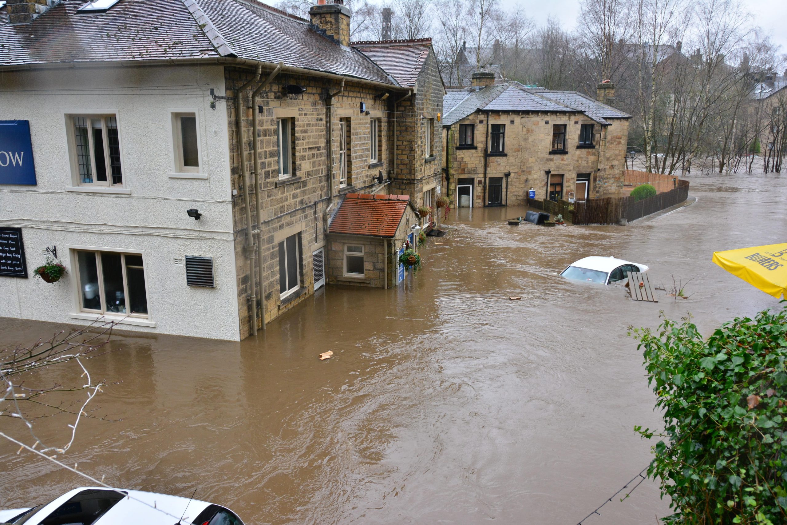 Homes flooding with muddy water in street