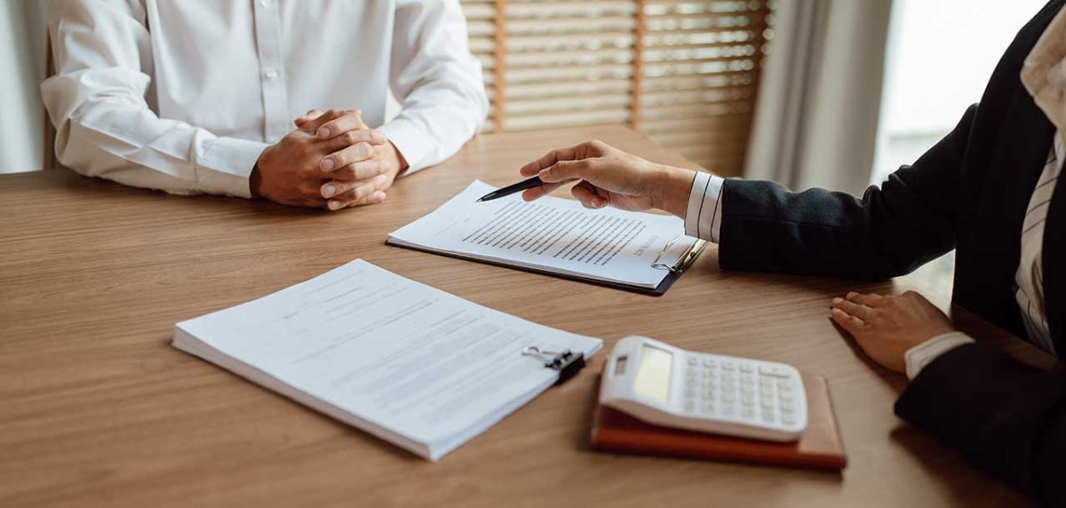 man signing papers