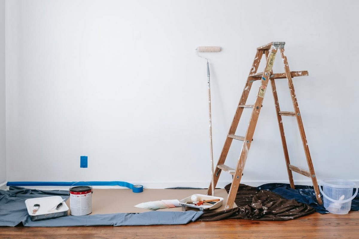 white wall in home with ladder and paint roller