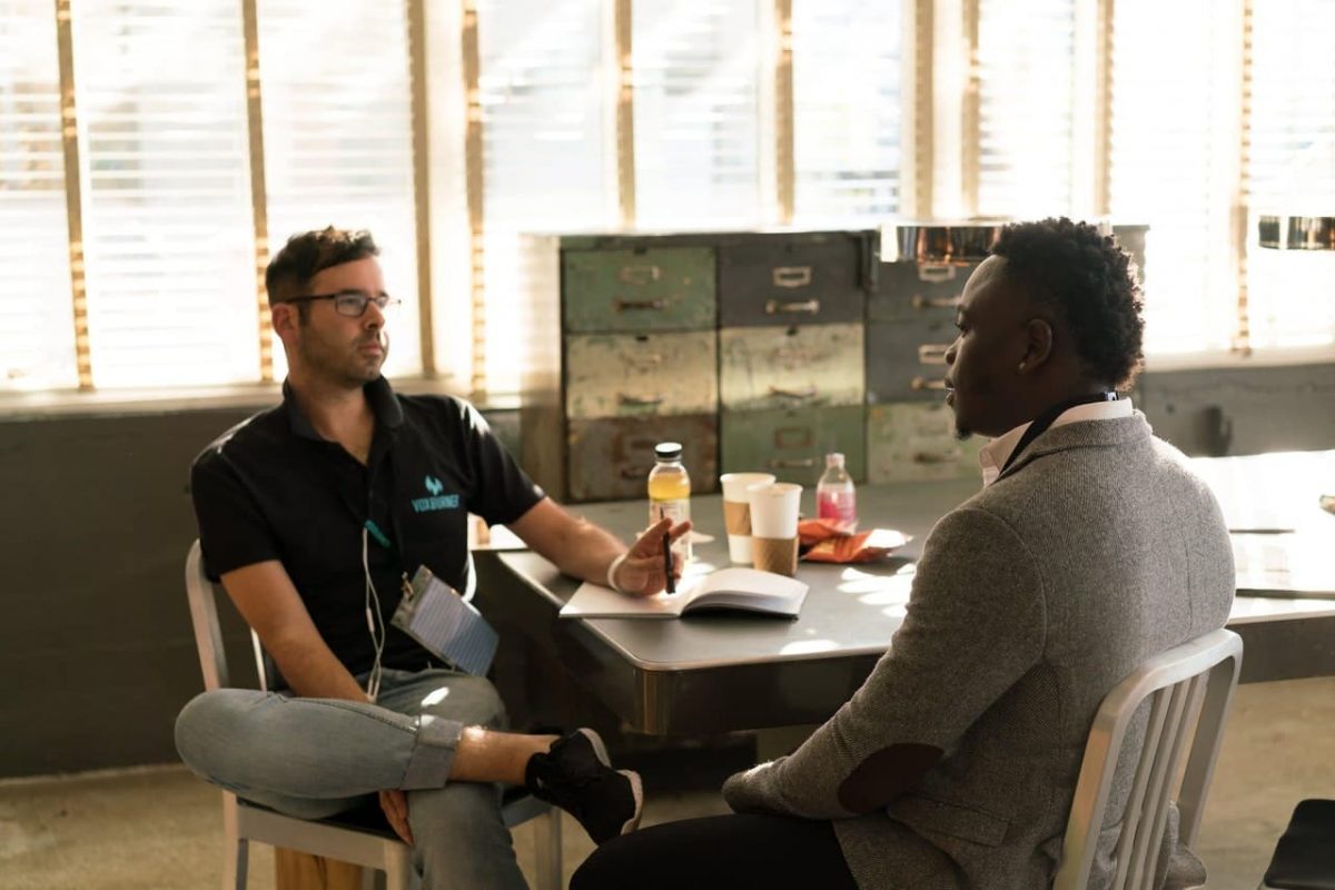 Two people hold a meeting.